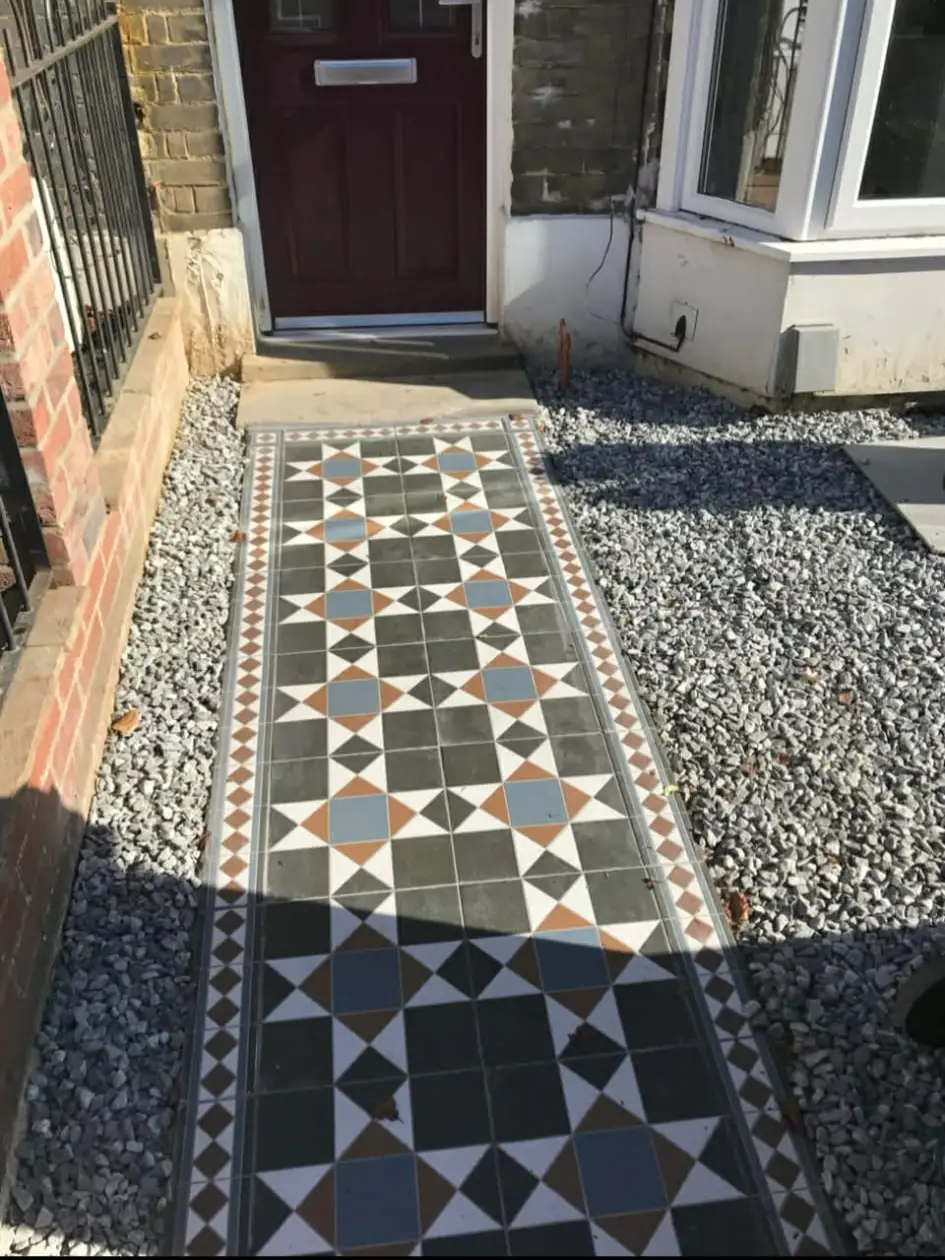 Stone garden path with geometric paving in bright greenery.