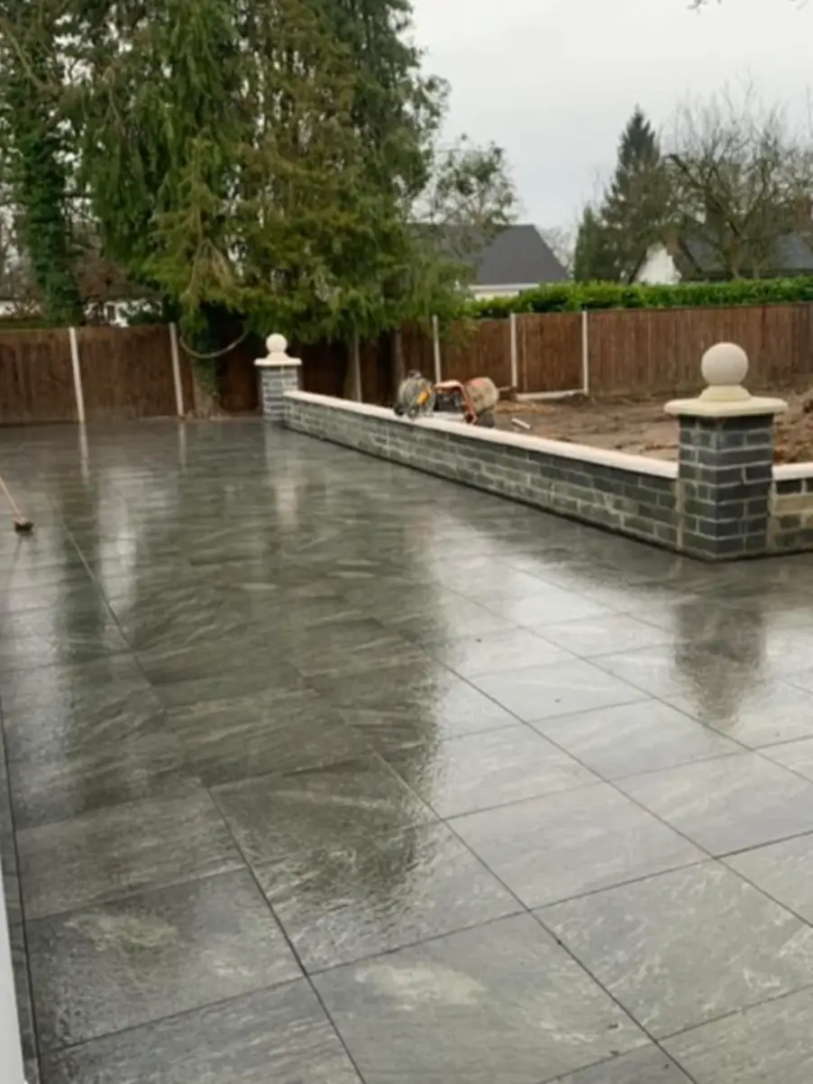 Patio adjoining new lawn with crisp edge.