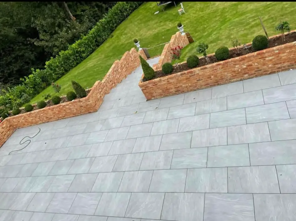 Patio framed with low rendered wall.